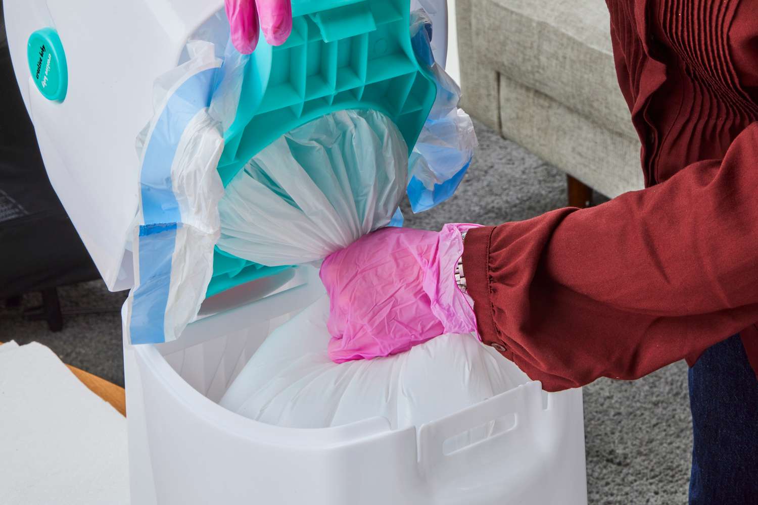 A person removes the bag from the Creative Baby Tidy Diaper Pail