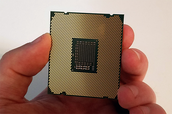 An Intel Core i7 processor held in hand