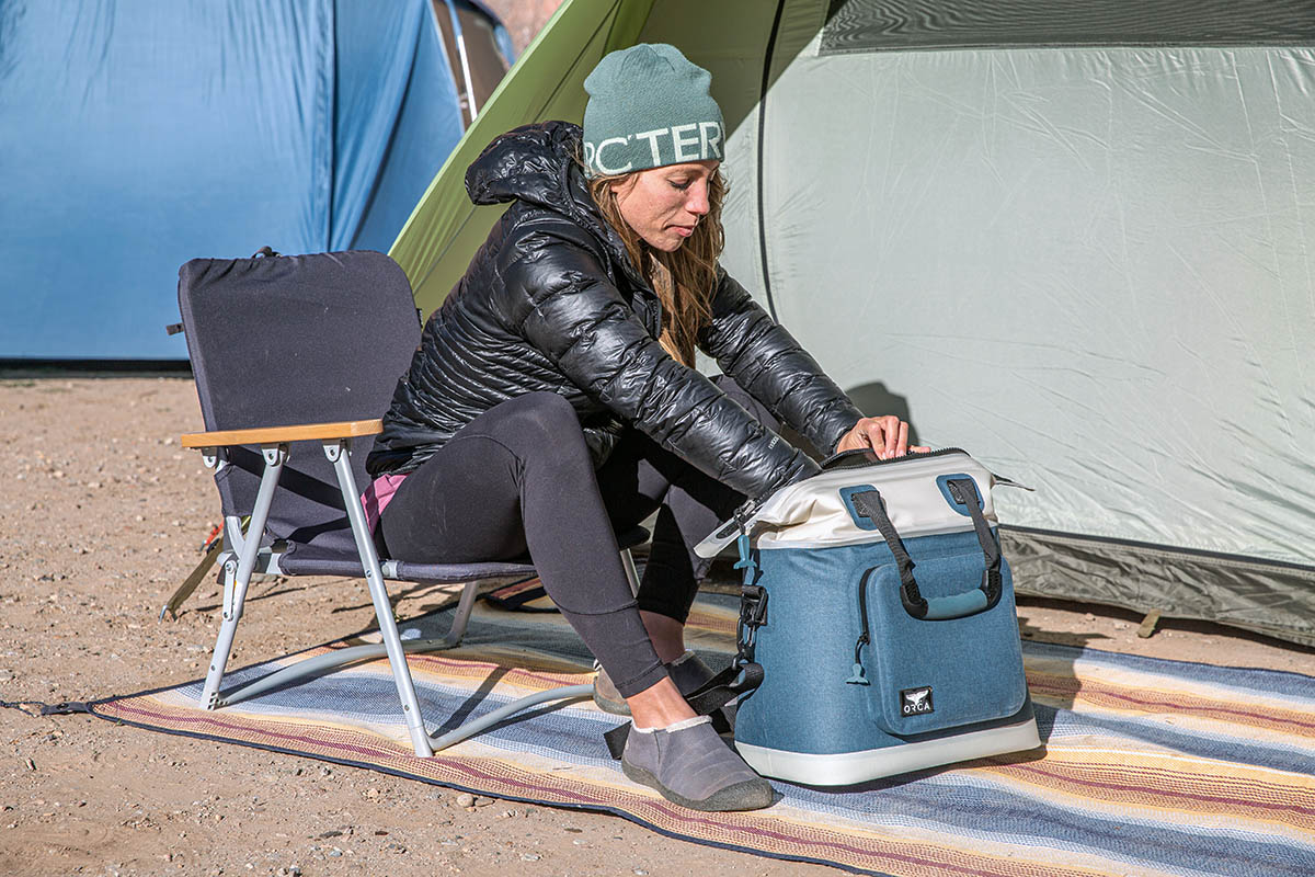 Camping chair (REI Co-op Outward Low Lawn Chair reaching into ORCA cooler)