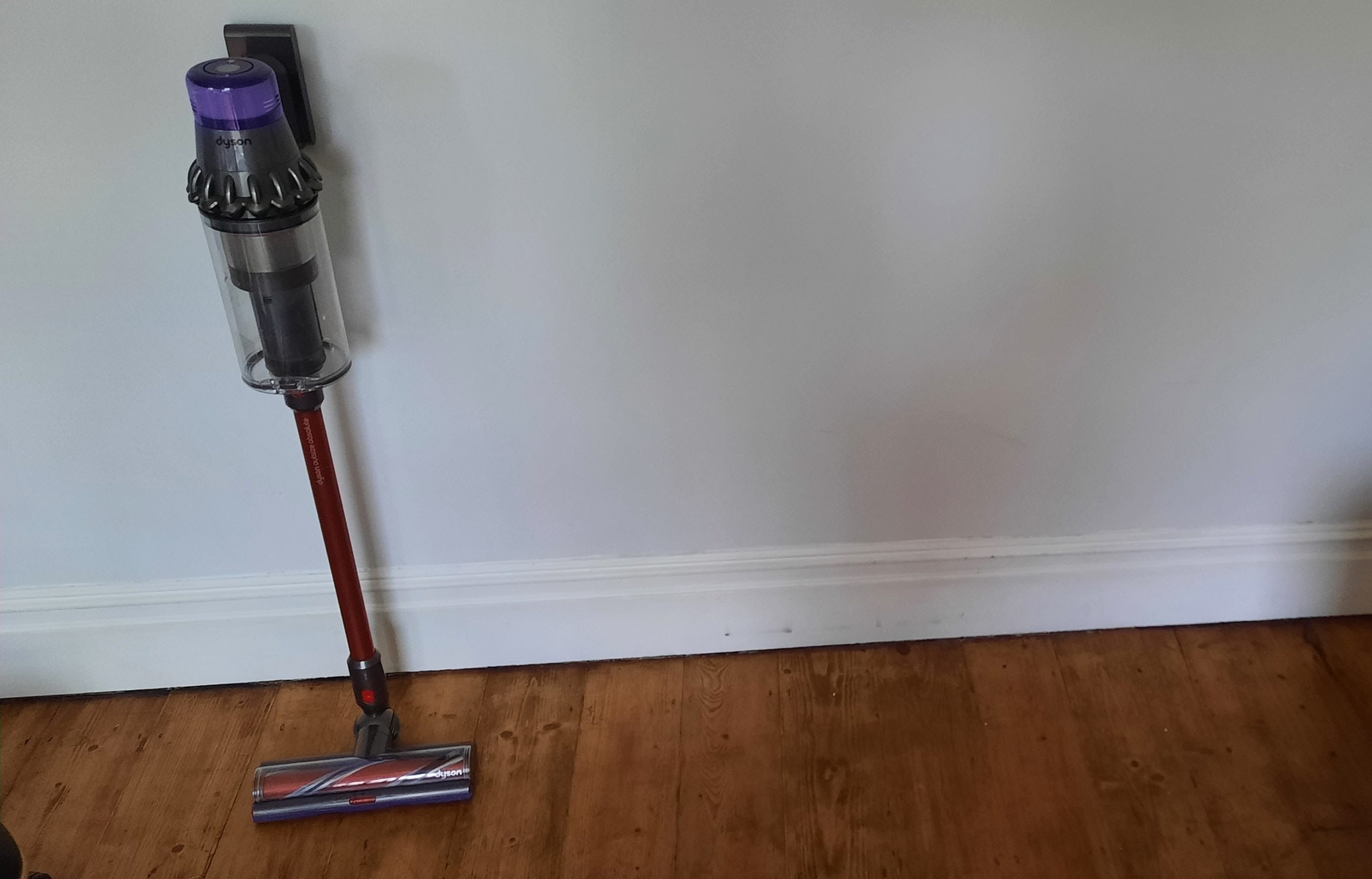 dyson v11 outsize stood next to wall