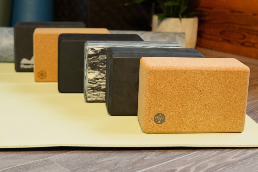 manduka gaiam alo lululemon yoga blocks sitting on yellow yoga mat